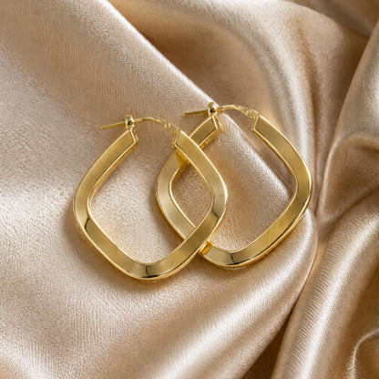Star Jewellers Twisted Hexagon 14ct Gold Plated Hoops displayed on champagne satin